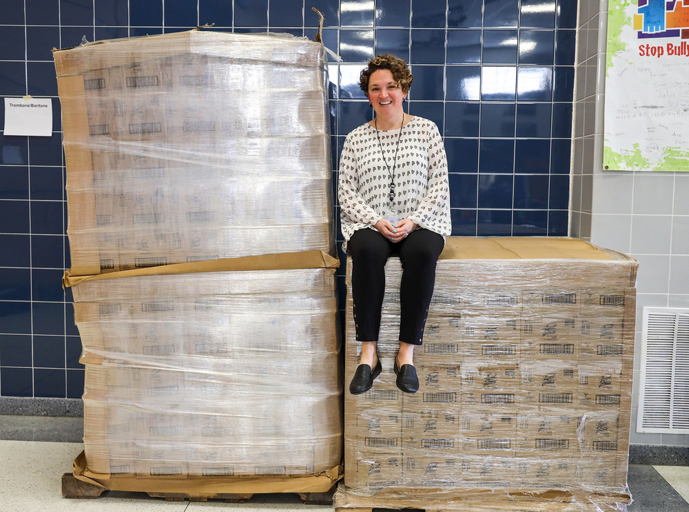 Principal Sitting on Stacked Pallets